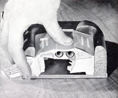 Black and white photo showing a cut away of a Catseye, with one set of wipers pulled away to show the flexible housing
