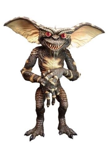 Picture of a standing gremlin. He is dark and scaly. His eyes are glowering at the viewer menacingly