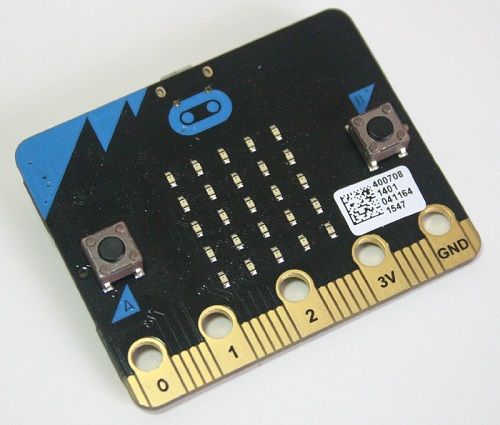 A picture of the Micro:Bit and its packaging. It has a 5x5 array of LEDs in the middle, with a button either side.